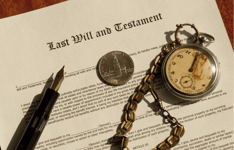An image of a last will and testament, with a pocket watch on top